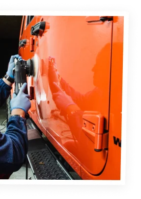 a mechanic buffing truck doors at Schroeder Truck Repair