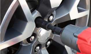 lug nuts being loosened on a tire